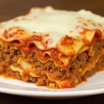 Lazy Lasagna Recipe - A cheesy and hearty slice of lasagna with layers of rich marinara, ground beef, and melted mozzarella cheese.