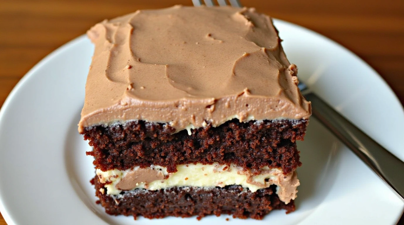 Texas Sheet Cake Recipe featuring moist chocolate cake layers with creamy frosting and a rich chocolate filling, served on a white plate.